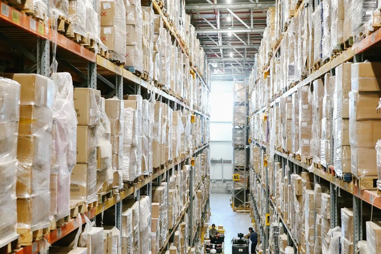 Catalogued boxes lining warehouse shelves, illustrating a software bill of materials as an inventory of components