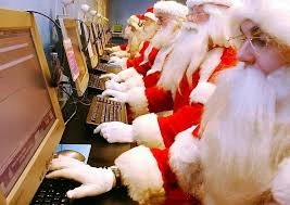 Santas working at computers