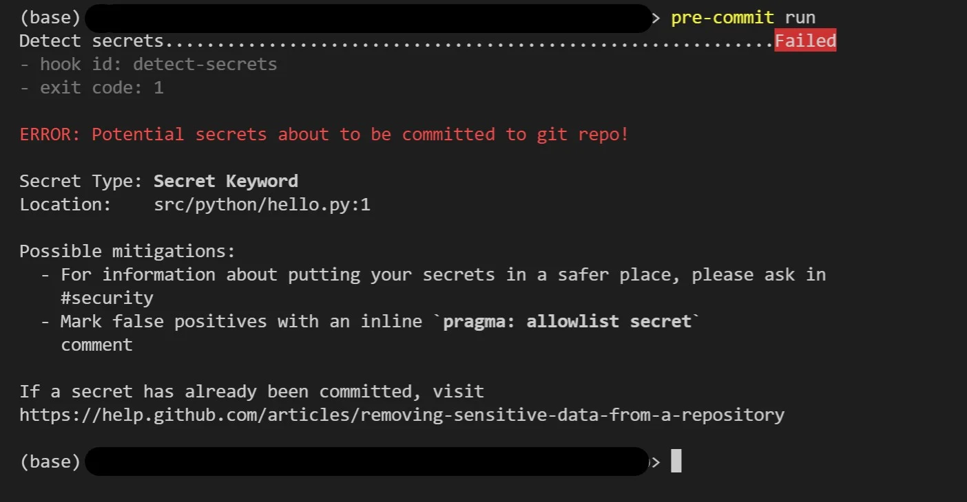 Real VS Code terminal output from a failed pre-commit run where the detect-secrets hook blocked a commit — the header shows 'Detect secrets........Failed', hook id: detect-secrets, exit code: 1, then 'ERROR: Potential secrets about to be committed to git repo!' with Secret Type: Secret Keyword and Location: src/python/hello.py:1, followed by mitigation guidance pointing developers to the #security channel or to mark false positives with an inline `pragma: allowlist secret` comment
